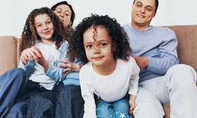 A stock photo of a happy family on a sofa